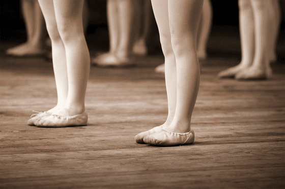 Dancer's feet are show with dance slippers on. 